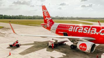 AirAsia aircraft being prepared for departure on the runway with ground crew