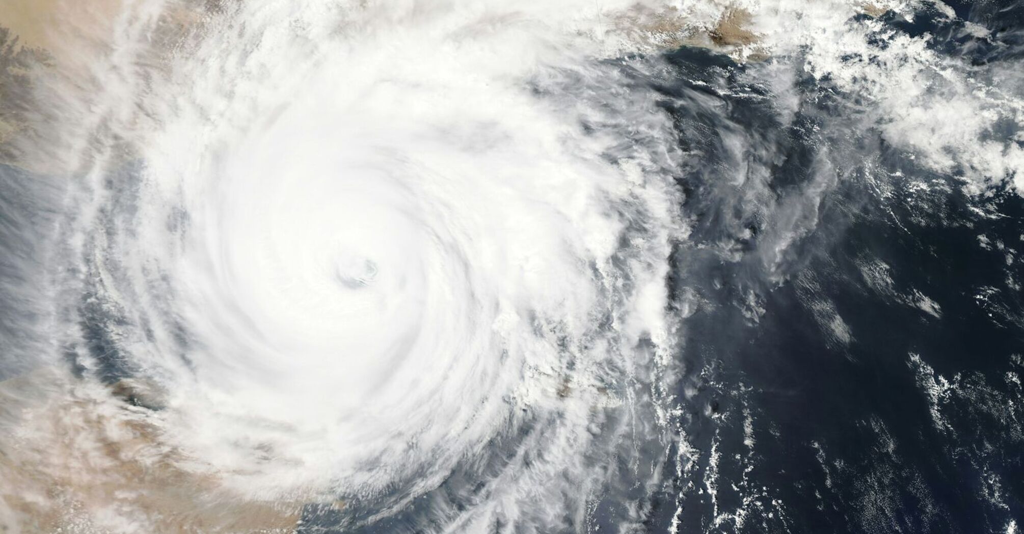 Satellite image of a powerful typhoon over the ocean near a coastline