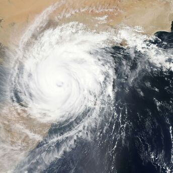 Satellite image of a powerful typhoon over the ocean near a coastline