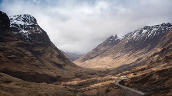 Misty Scottish mountain landscape with remaining snow patches