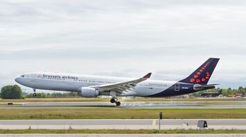 A Brussels Airlines aircraft landing on a runway, showcasing the airline's distinctive design and Belgian identity