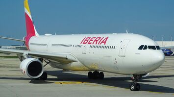 An Iberia airplane on the runway at an airport