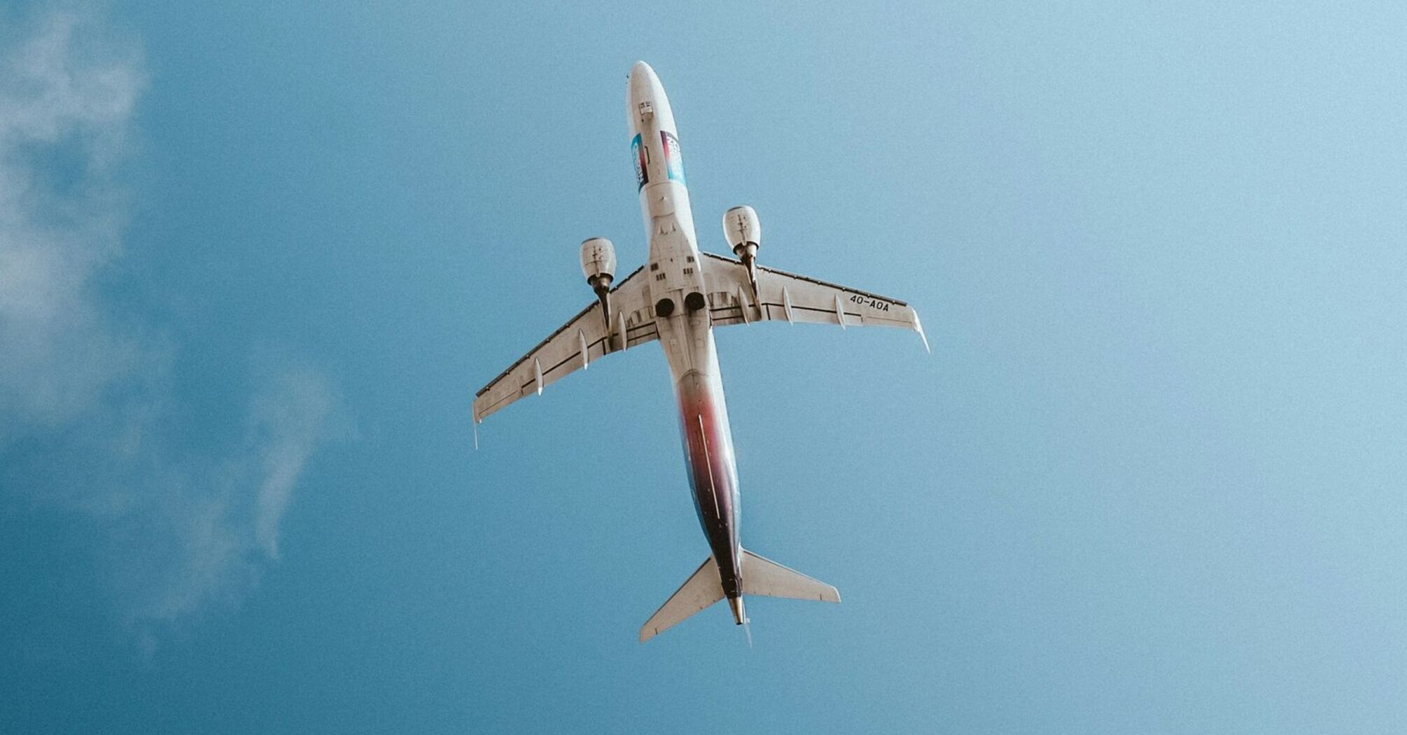 A Air Montenegro airplane flying high in the clear blue sky