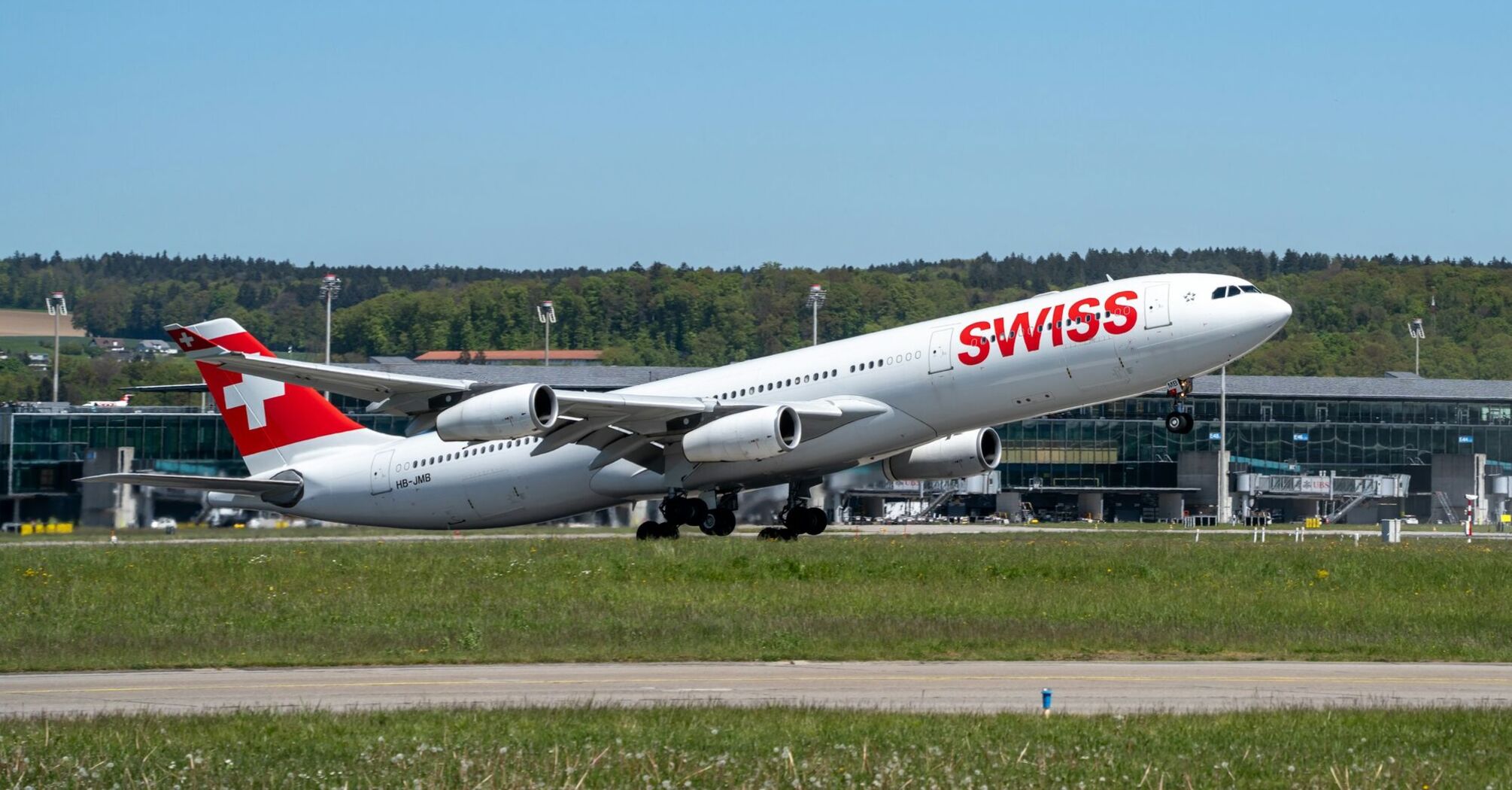 A SWISS aircraft taking off from Zurich Airport on a clear day