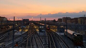 Sunset view over railway tracks at a train station in Italy