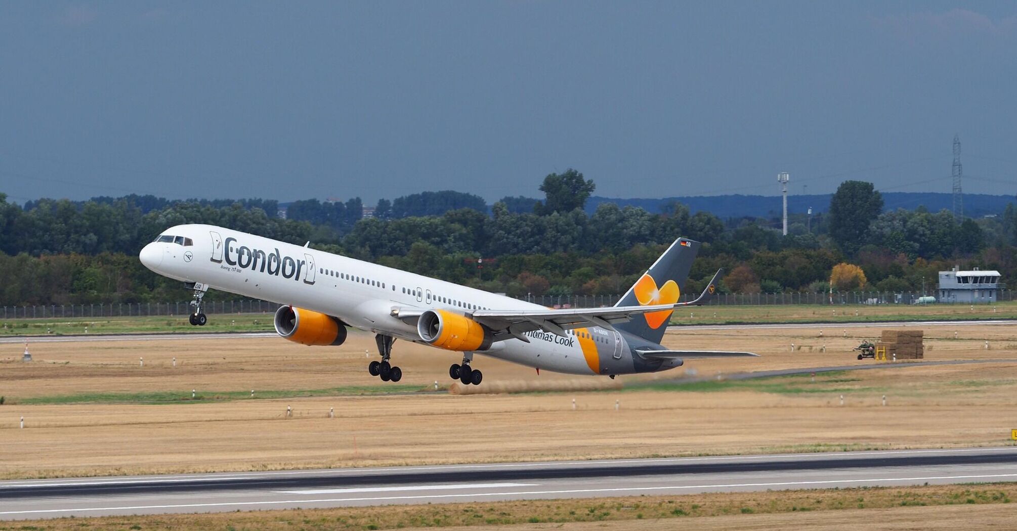 A Condor Airlines plane taking off from a runway on a clear day