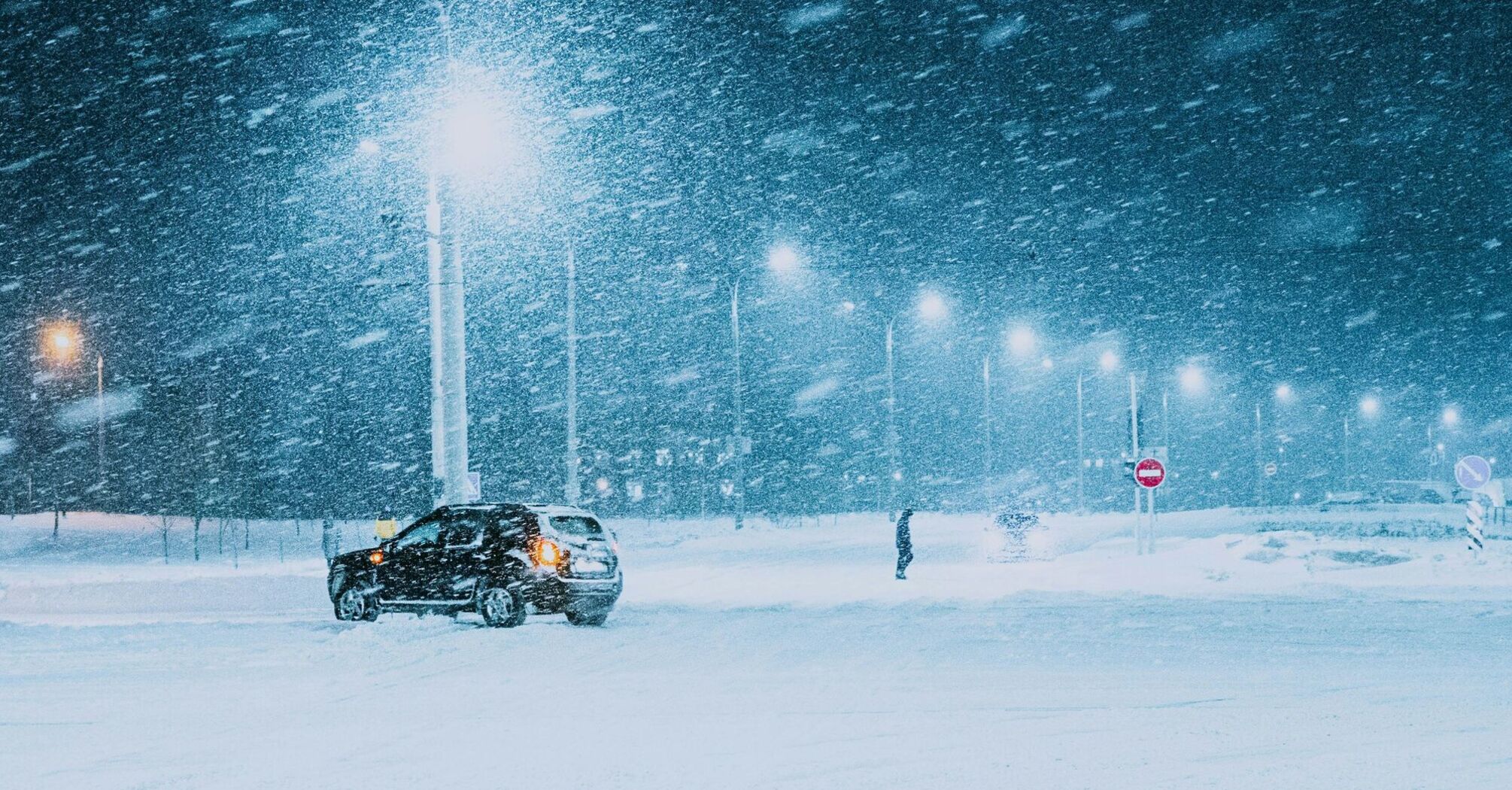 Snowstorm at night with a car