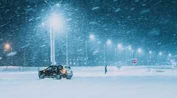 Snowstorm at night with a car
