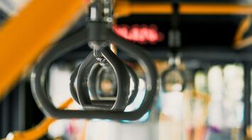 Interior of a public bus showing handrails and seats