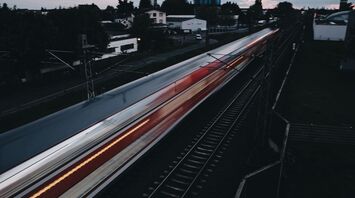 A high-speed train traveling at dusk