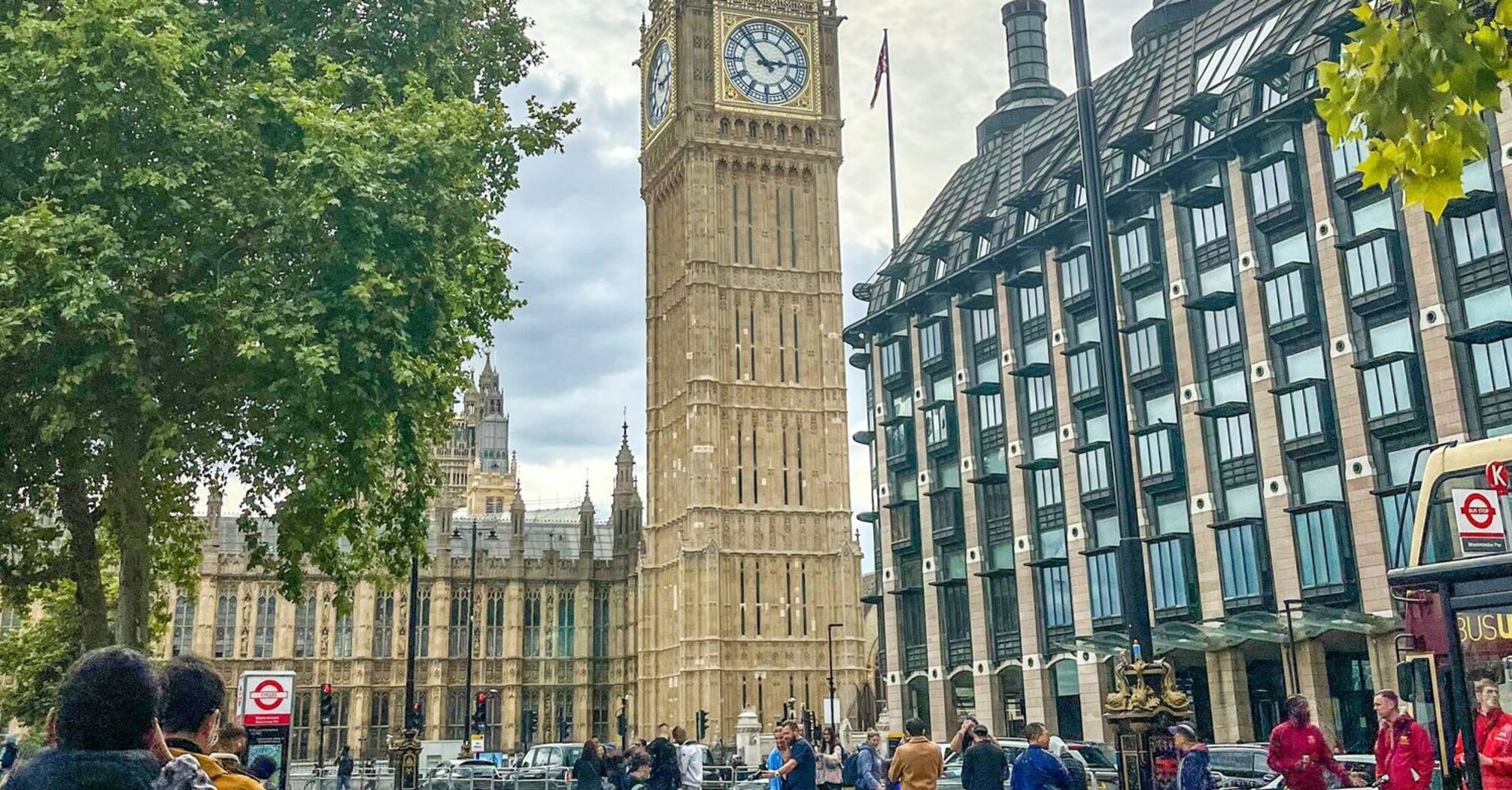 A street view of Big Ben and Westminster in London, with Santander bicycles and people in the foreground