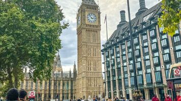A street view of Big Ben and Westminster in London, with Santander bicycles and people in the foreground