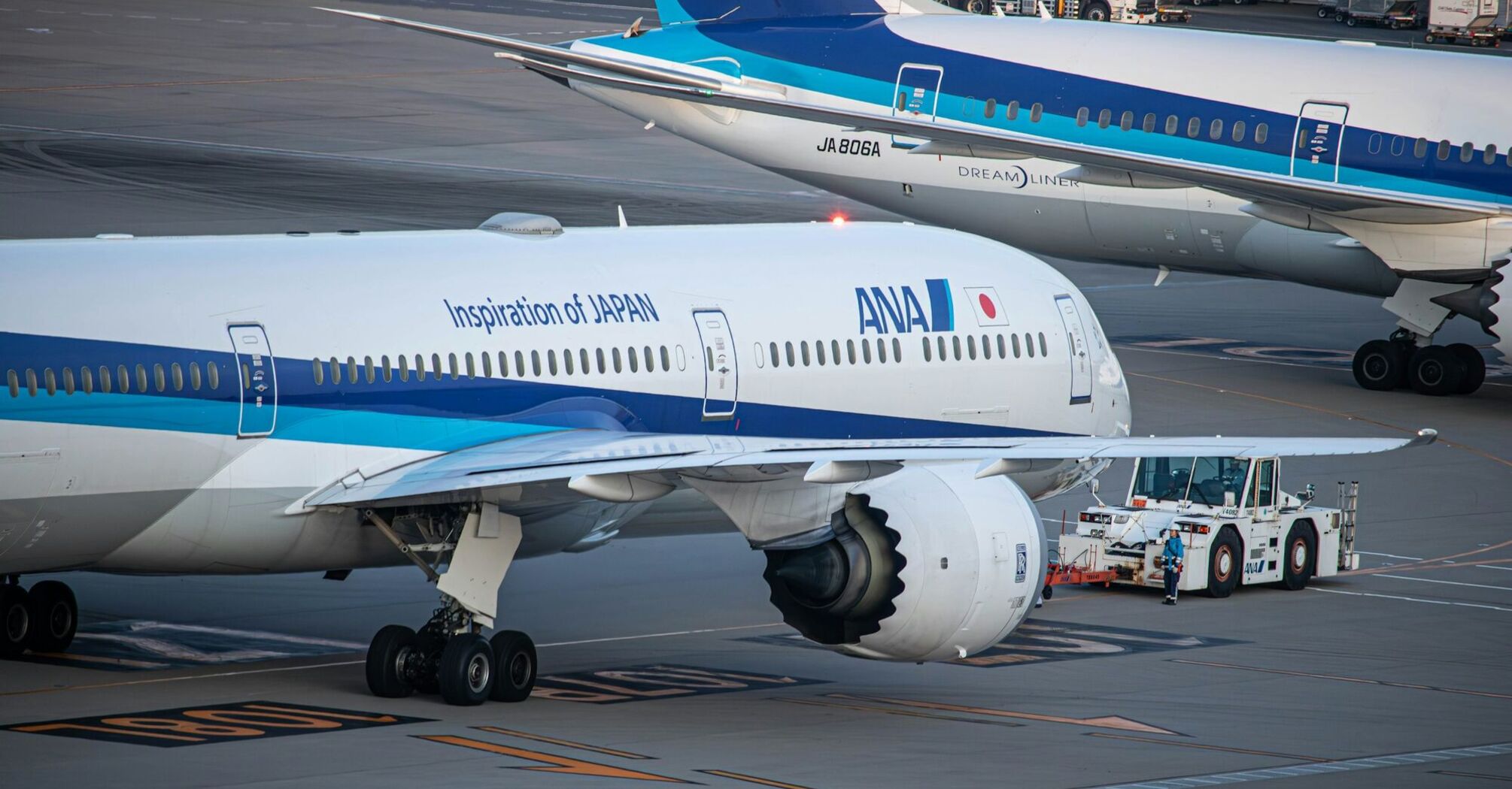 An ANA aircraft on the tarmac being prepared for departure, showcasing the "Inspiration of JAPAN" branding