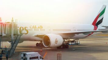 Emirates aircraft parked at an airport gate