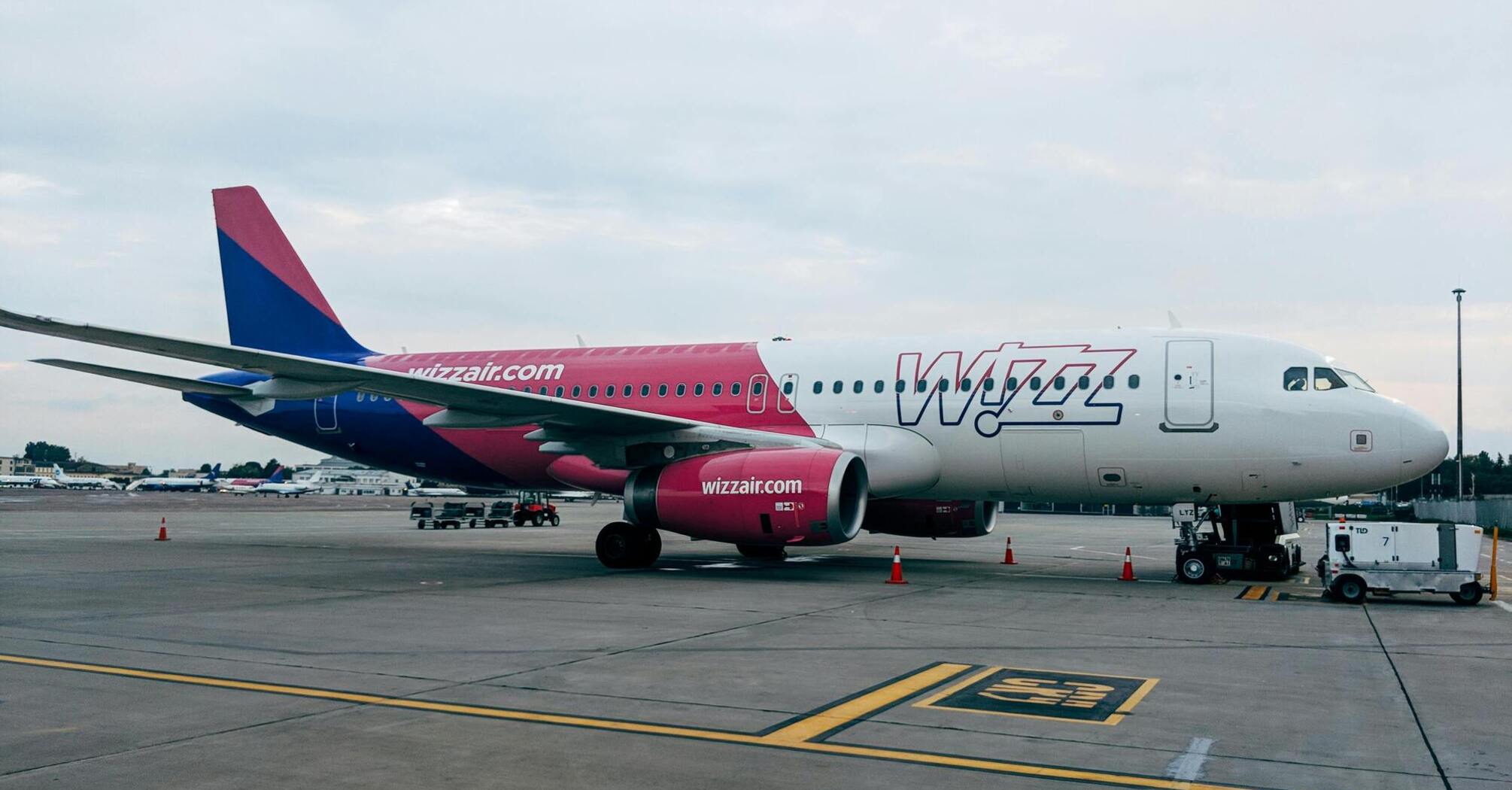 A Wizz Air plane parked at an airport runway