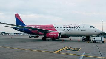 A Wizz Air plane parked at an airport runway