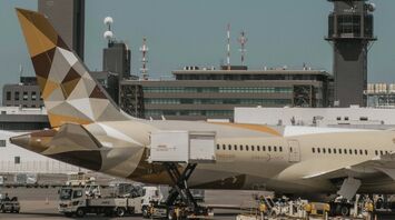 Etihad Airways plane at the airport with cargo loading and ground crew in operation