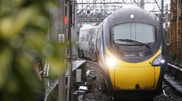 A stationary Avanti West Coast train at a railway station during overcast weather