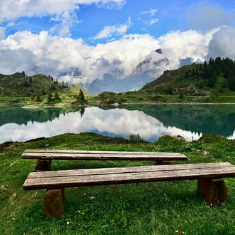 Peaceful Alpine lake surrounded by mountains