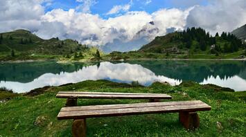 Peaceful Alpine lake surrounded by mountains