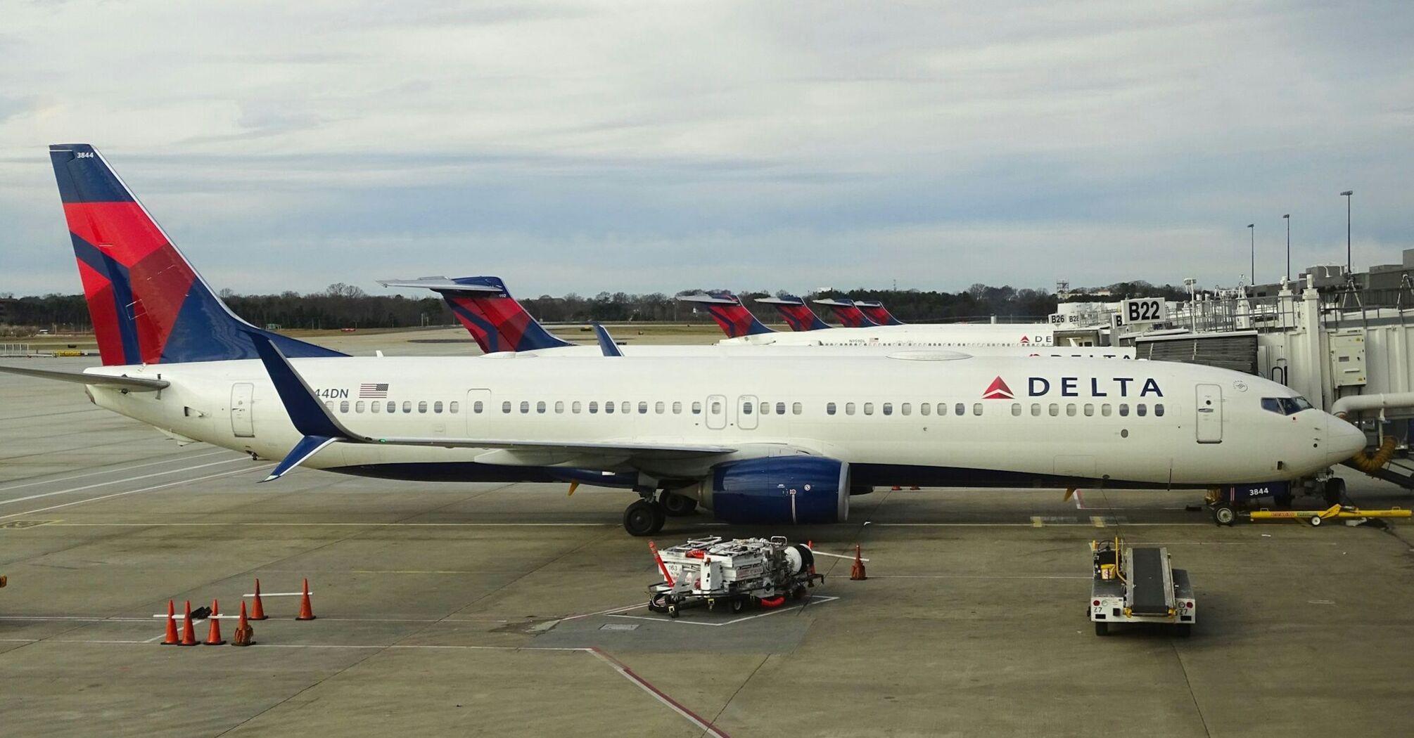 Delta Airlines aircraft parked at an airport gate ready for passenger boarding