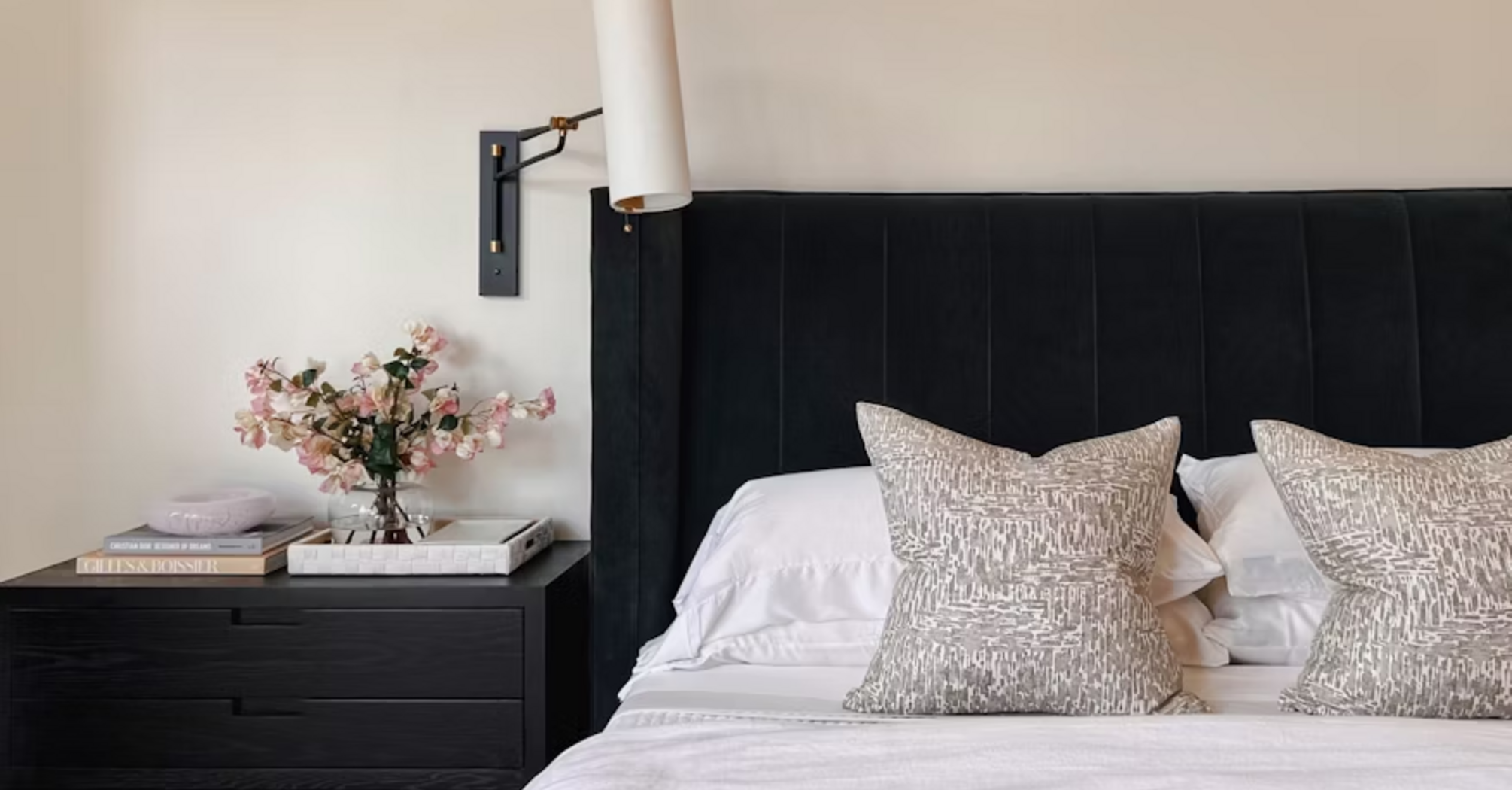 Modern hotel bedroom with neatly made bed and bedside table