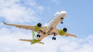 airBaltic Airbus A220 taking off against a blue sky