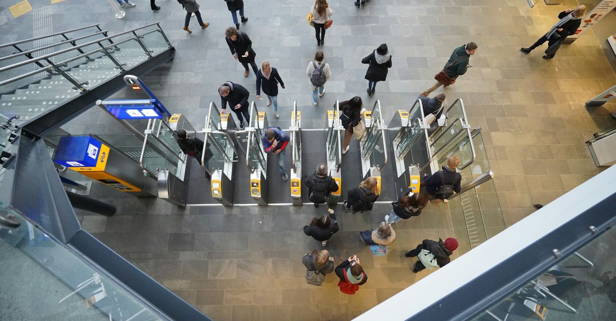 Travellers passing through automated gates at an airport terminal