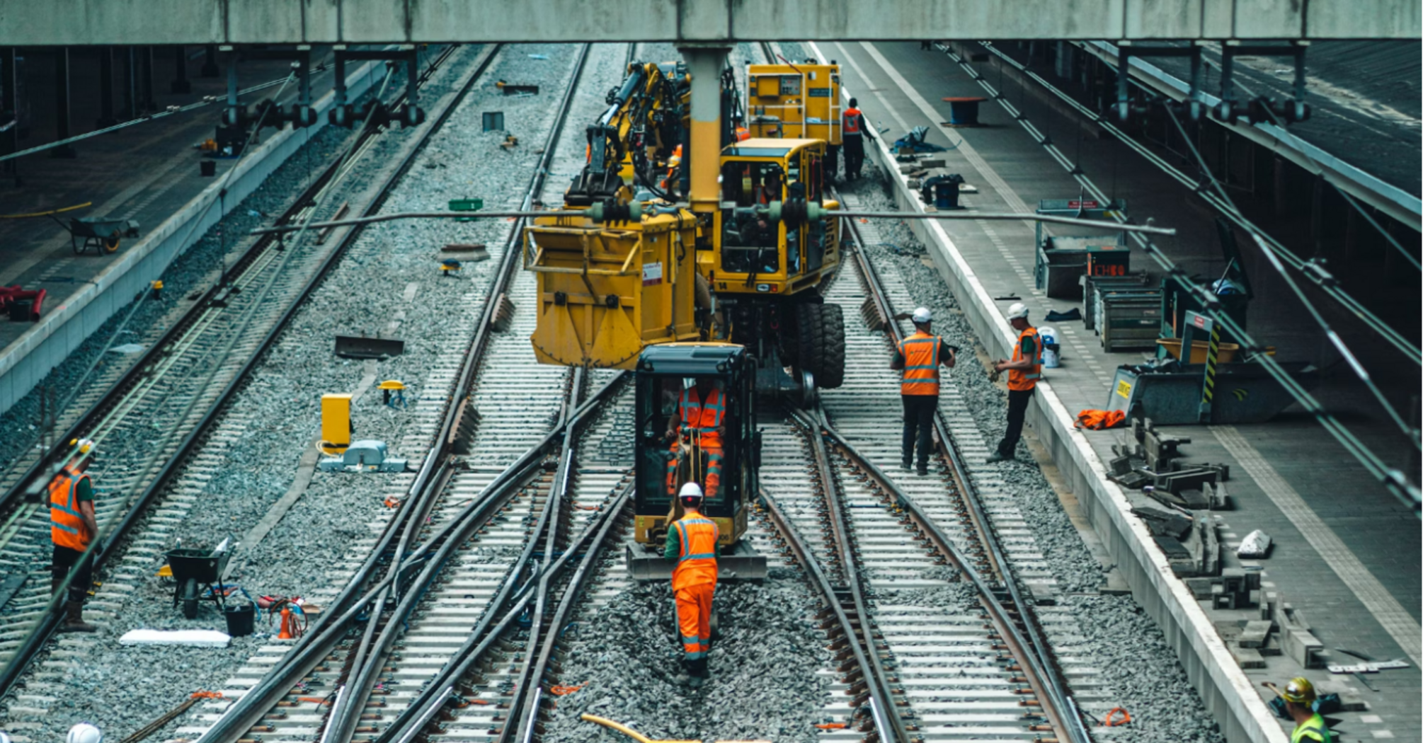 Railway engineers carrying out track maintenance and upgrades on a busy mainline