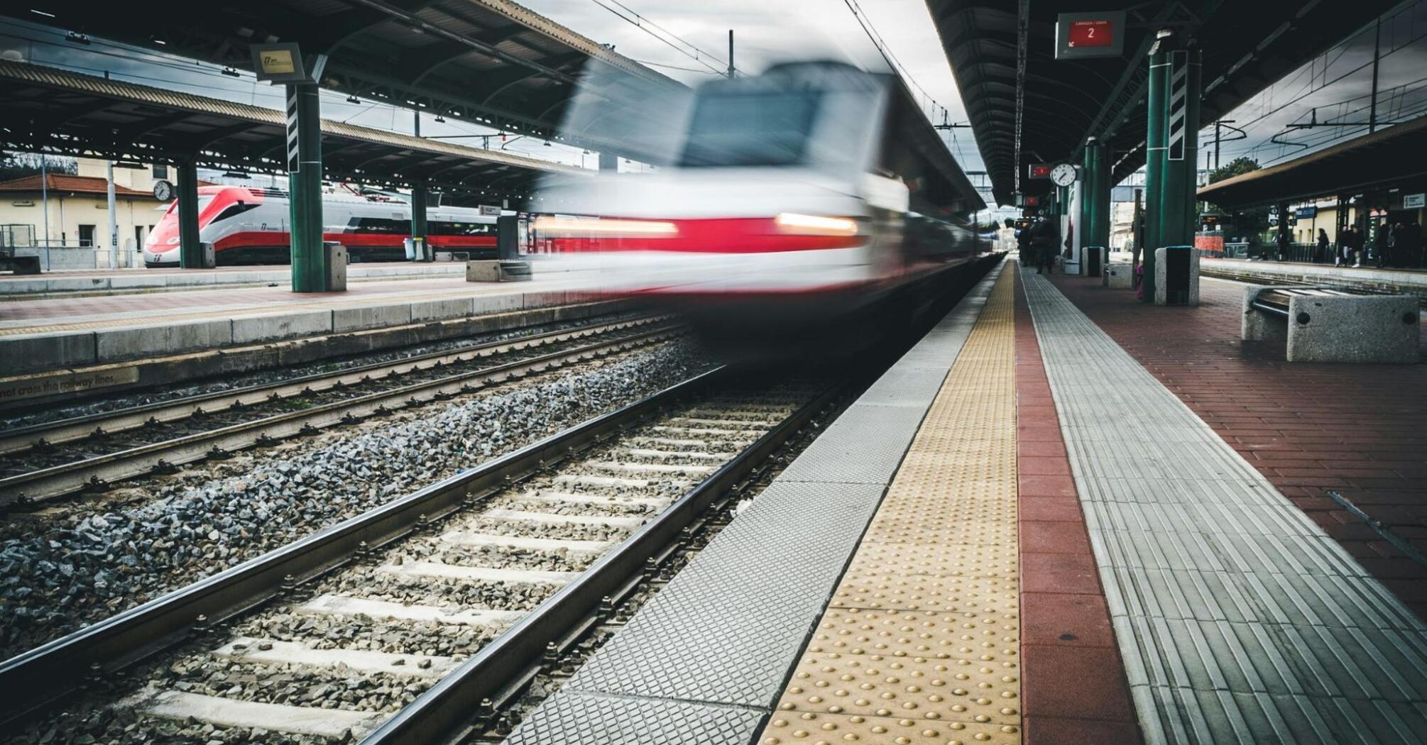 A high-speed train arriving at a European station platform
