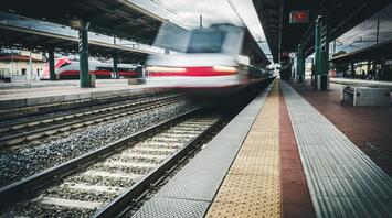 A high-speed train arriving at a European station platform