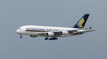 Singapore Airlines Airbus A380 in flight under a cloudy sky