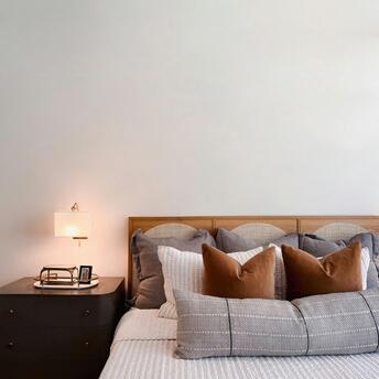 Modern hotel bedroom with minimalist décor and soft lighting