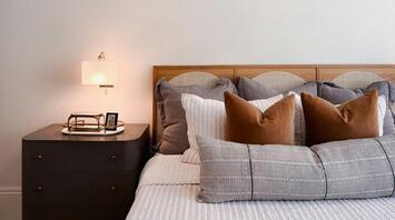 Modern hotel bedroom with minimalist décor and soft lighting