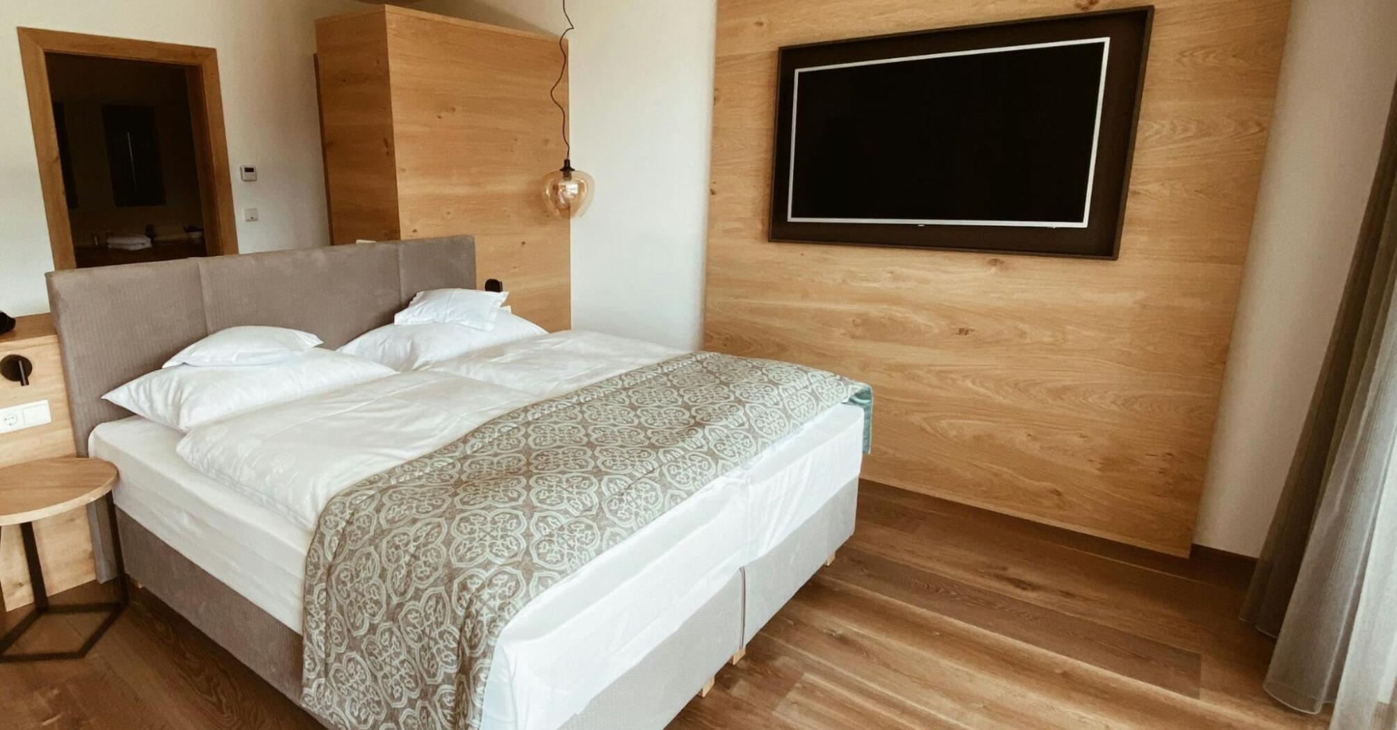 Cozy modern hotel room with wooden accents and soft lighting