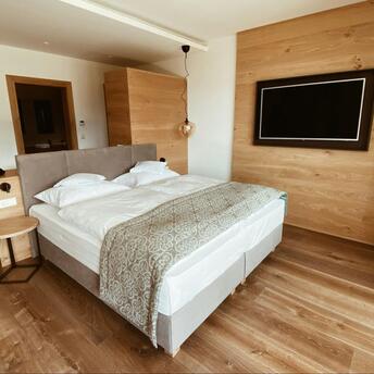 Cozy modern hotel room with wooden accents and soft lighting