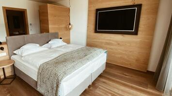 Cozy modern hotel room with wooden accents and soft lighting