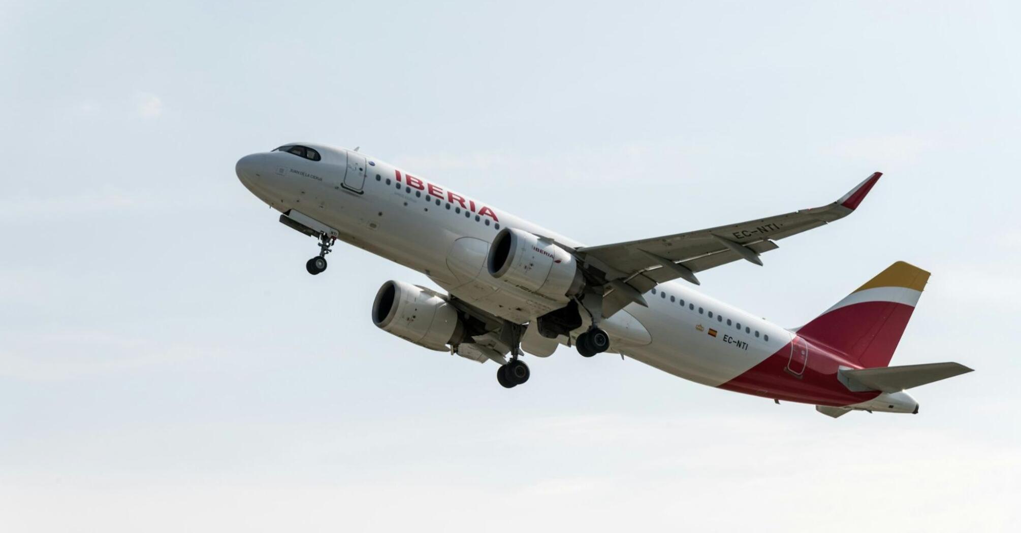 Iberia aircraft taking off from runway against a clear sky