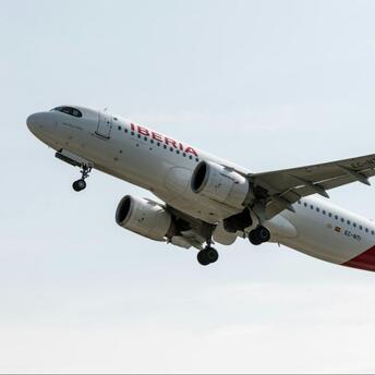Iberia aircraft taking off from runway against a clear sky