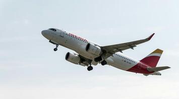 Iberia aircraft taking off from runway against a clear sky