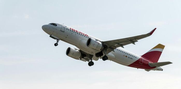 Iberia aircraft taking off from runway against a clear sky