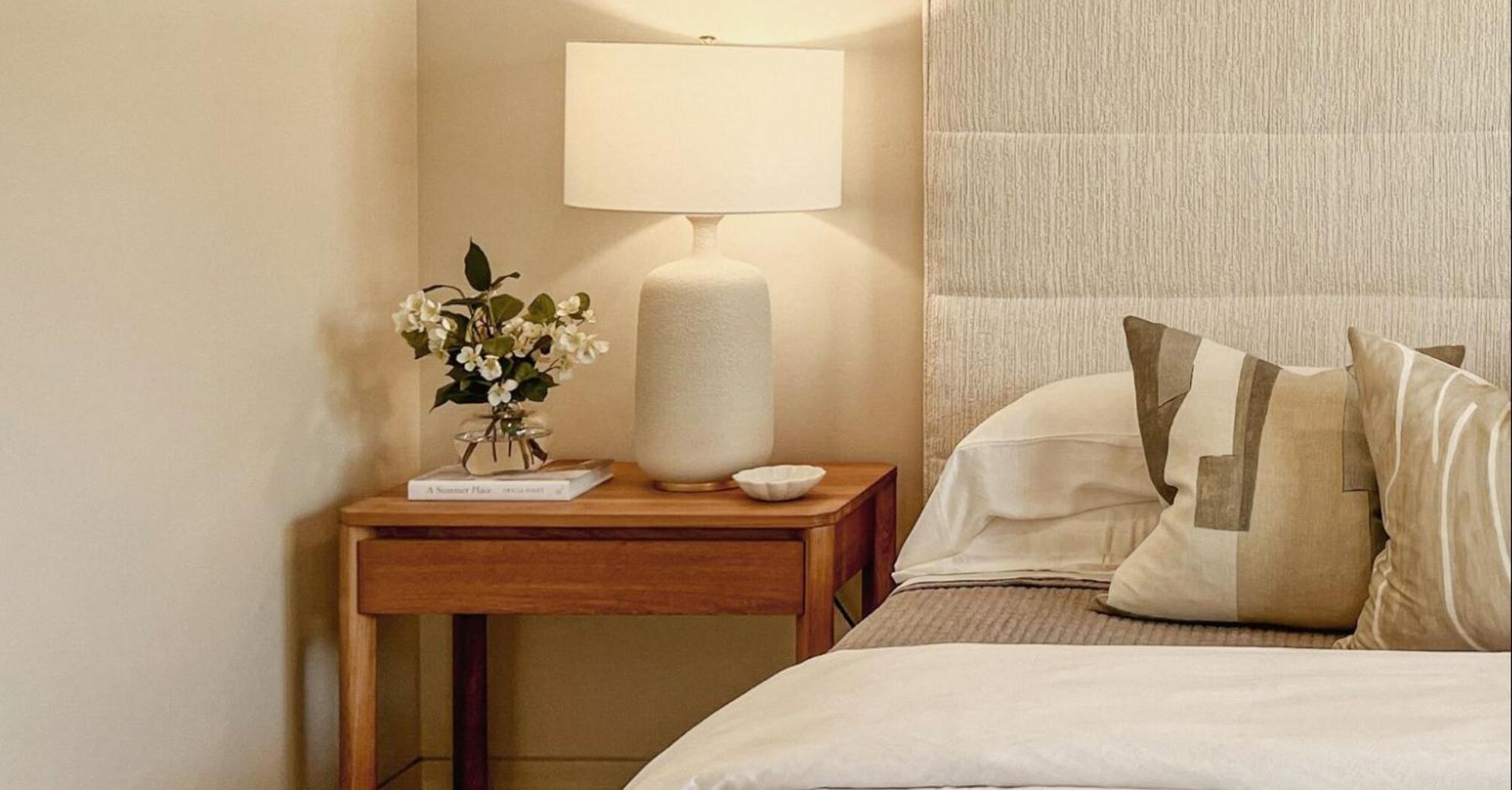 Minimalist hotel bedroom with soft lighting and neutral tones