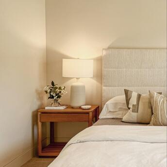 Minimalist hotel bedroom with soft lighting and neutral tones