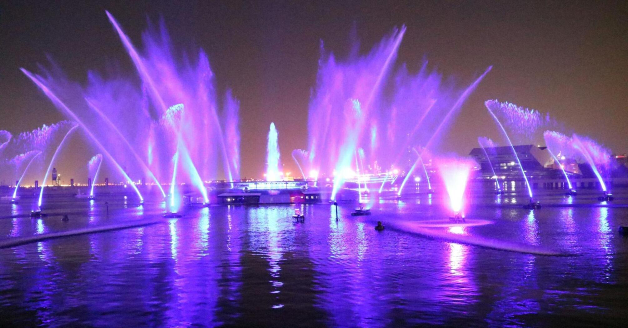 Colorful light fountains illuminating Liverpool’s waterfront at night during the River of Light festival