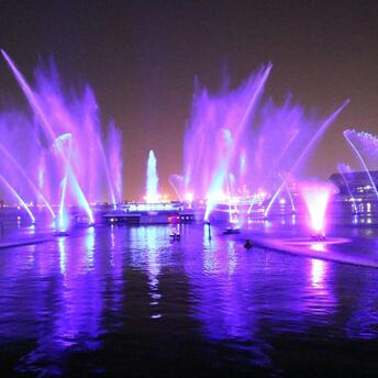 Colorful light fountains illuminating Liverpool’s waterfront at night during the River of Light festival