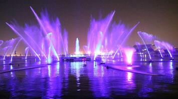 Colorful light fountains illuminating Liverpool’s waterfront at night during the River of Light festival