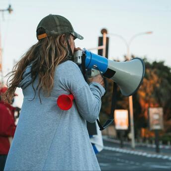 Person using a megaphone during a public protest in Italy