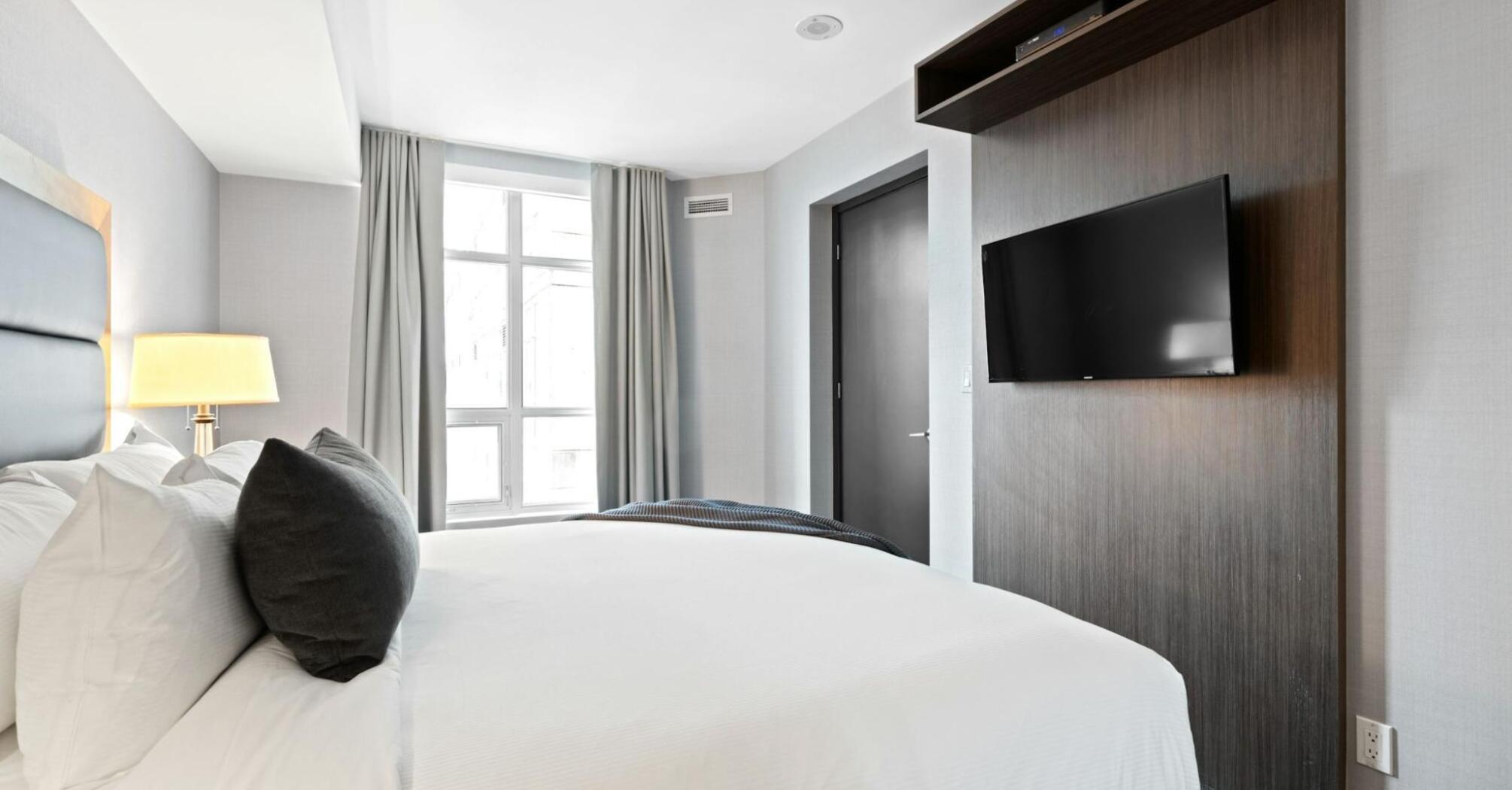 Modern hotel room with large window and minimalist décor
