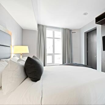 Modern hotel room with large window and minimalist décor