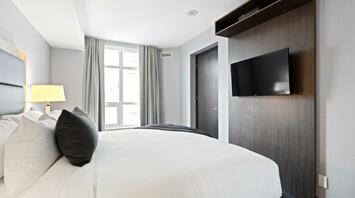 Modern hotel room with large window and minimalist décor